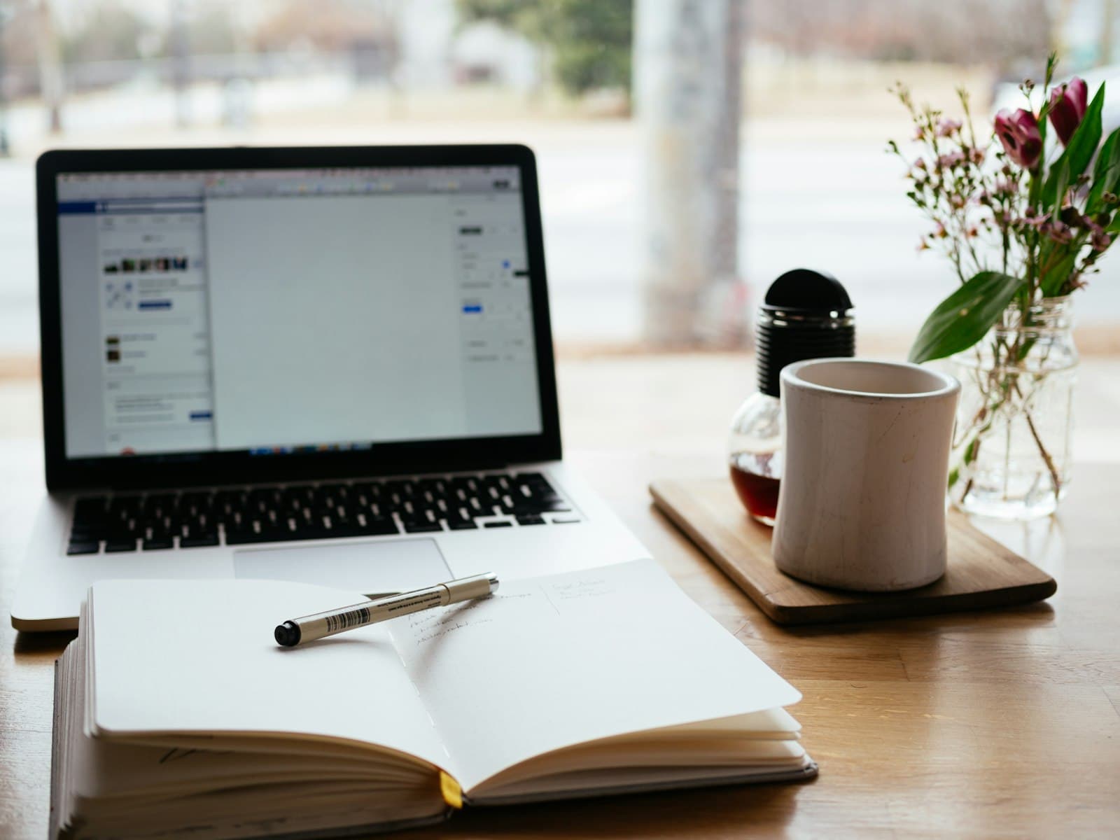 Notebook and coffee on a desk evoking editorial research and writing