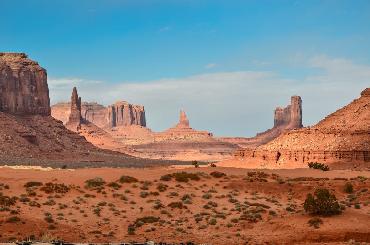 Sand dunes under a wide desert sky at golden hour